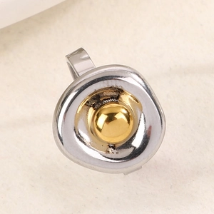 Macro detail of minimalist two-tone irregular metal ring with gold and silver finish