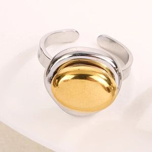 Detail of minimalist two-tone open ring with polished gold oval and silver band