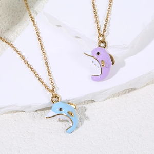 Detail of cute enamel dolphin pendants in light blue and lavender on gold chains