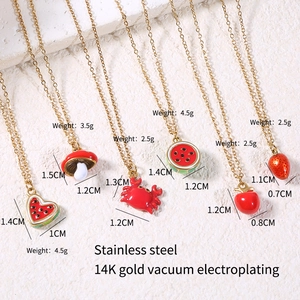 Detail of 14K gold plated stainless steel necklaces with colorful enamel fruit pendants