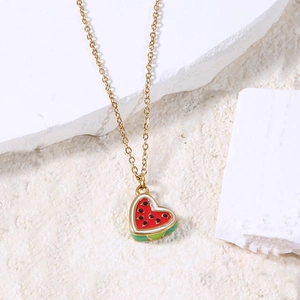 Macro view of gold heart watermelon pendant necklace with vibrant enamel detail
