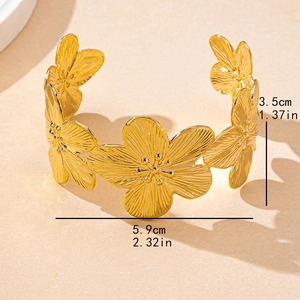 Vintage golden flower open bangle with detailed petal texture and floral design