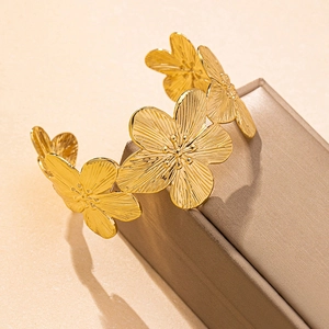 Golden flower statement cuff bracelet with matte brushed petals and floral bridal design