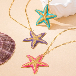 Starfish pendant necklace set in blue, purple and pink on a beach sand background
