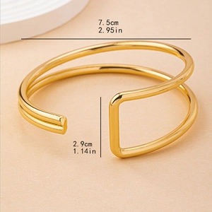 Minimalist double-layered gold geometric open bangle showing exact size measurements