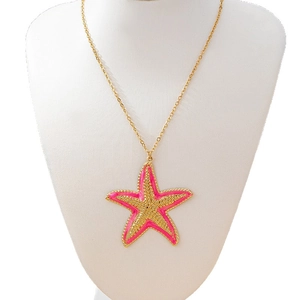 Pink starfish pendant necklace with gold chain for women in a bohemian beach style