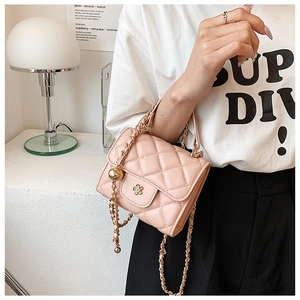Detail of light pink quilted mini crossbody bag with gold chain and flower clasp