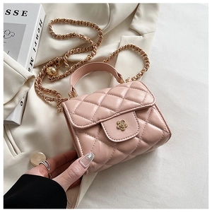 Detail of pink quilted mini bag featuring golden camellia lock and metal chain strap