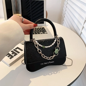 Elegant black crocodile texture crossbody bag with gold chain and pearl strap detail