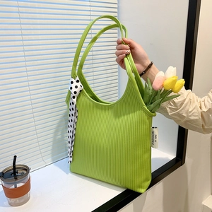 Lime green pleated underarm bag for women with polka dot scarf and fashion label