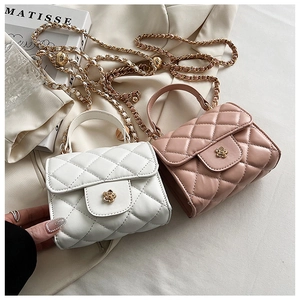 Detail of quilted mini flap bags in cream and pink with chain straps and flower buckles