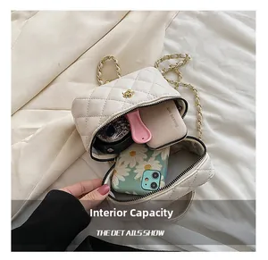 Internal capacity of white quilted mini chain bag with camellia detail and daily items