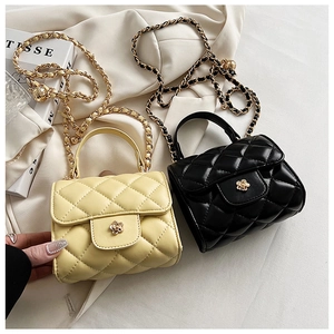 Detail of quilted mini bags with gold chain straps and camellia-shaped metal clasps