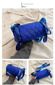 Detailed blue quilted nylon cylinder crossbody bag with adjustable wide strap