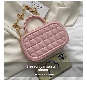 Pink quilted box bag size comparison with a smartphone on white fabric background