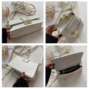 Detailed views of a white crocodile embossed leather handbag with gold metal hardware