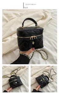 Detail of black quilted leather mini bag with chain strap and flower zipper pull