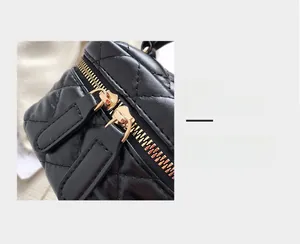 Detailed macro view of quilted black leather texture and smooth golden dual zippers