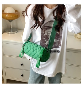 Quilted nylon cylinder crossbody bag in bright green with matching wide fabric strap