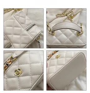 Detail shots of white quilted leather bag with golden camellia flower and chain strap