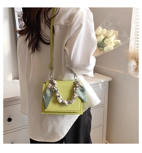 Lime green crossbody square bag with silk scarf wrapped handle and adjustable strap