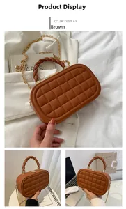 Detailed view of brown quilted crossbody box bag with braided handle and gold chain strap