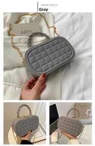 Gray quilted PU leather box bag with braided handle and gold chain detail view