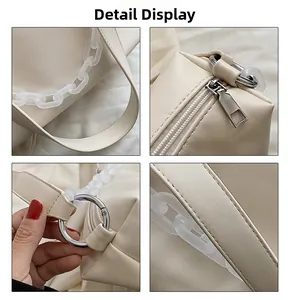Close-up of cream PU leather handbag detailing metal zipper and acrylic chain links