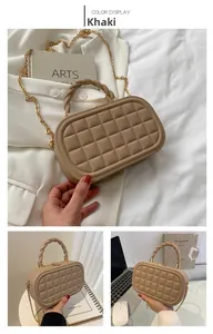 Detail of khaki box bag featuring quilted leather texture and a twisted rope handle