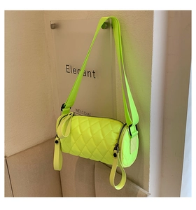 Detail of neon green quilted nylon cylinder bag with adjustable wide strap