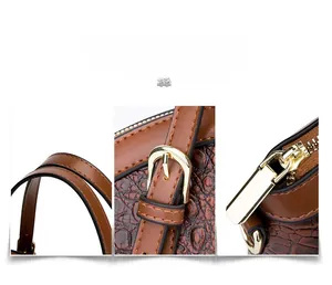 Close-up of brown crocodile texture leather bag with golden zipper and handle detail