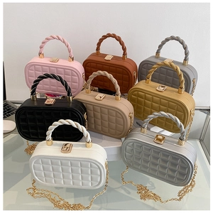 Close-up of quilted box clutch bags in eight colors featuring gold chain straps