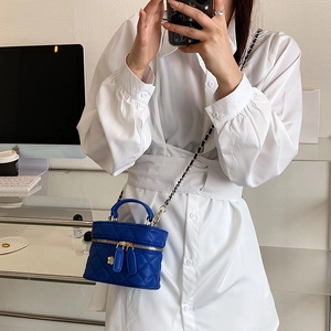 Royal blue quilted mini crossbody bag with metal chain strap and flower decoration