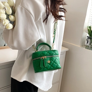 Green quilted mini crossbody bag with gold floral detail and chain strap for women