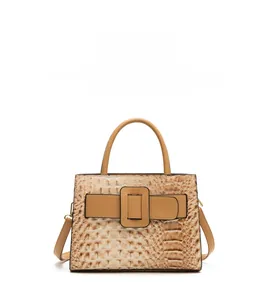 Detail shot of vintage crocodile pattern texture on a light brown shoulder handbag