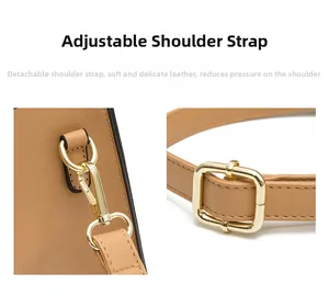 Detail of adjustable camel shoulder strap with metal hooks and buckle for women's handbag