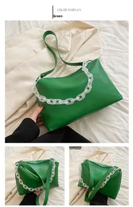 Detail view of green PU leather baguette bag with thick translucent acrylic chain strap