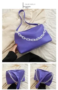 Detailed view of periwinkle blue shoulder bag with chunky acrylic chain strap