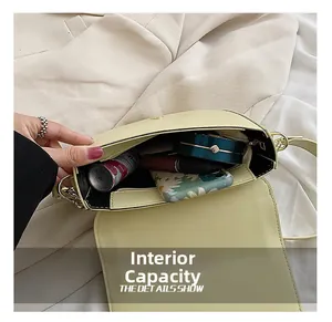 Macro view of the internal capacity of a pale yellow saddle bag with several items