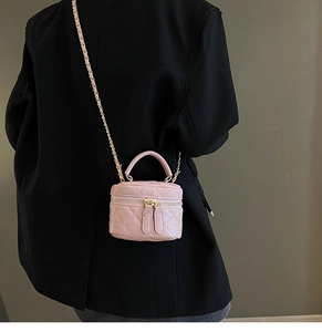 Detailed back view of a pink quilted mini crossbody bag with gold-tone chain strap
