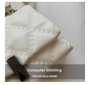 Macro detail of high-quality computer stitching on white quilted leather shoulder bag