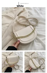 Detail of white saddle bag with smooth PU leather finish and chunky gold chain strap