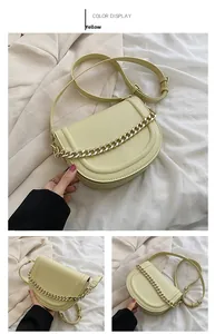 Detail view of yellow saddle bag with chunky gold chain and adjustable leather strap