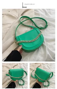 Detail of green saddle bag showing matte leather texture and decorative gold chain strap