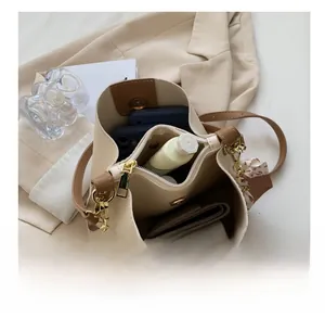 Detailed view of spacious bucket bag interior with organized items and floral scarf detail