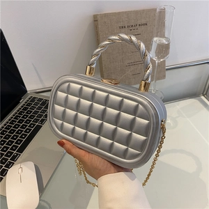 Silver quilted box clutch bag with gold twisted handle and metal chain for women