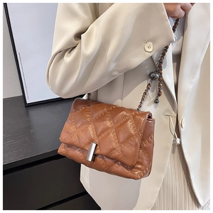 Detail of brown quilted shoulder bag with chain strap and metallic square lock