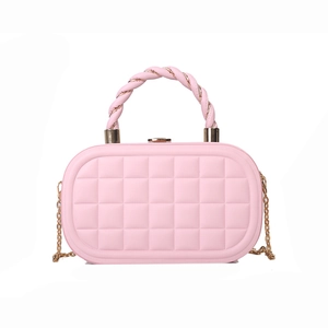 Elegant pink quilted box bag with a unique twisted handle and gold chain shoulder strap