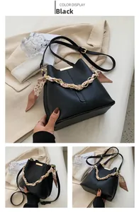 Detail view of black bucket bag with gold chain wrapped in leopard print scarf