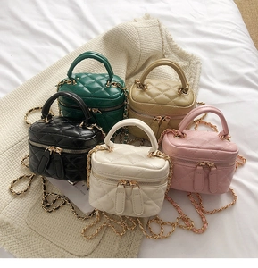 Quilted mini crossbody box bags in five colors with chain straps on textured fabric